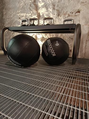 two balls sitting on top of a metal rack at Hotel D H Lawrence in Cagliari
