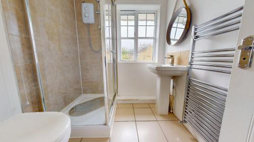 a bathroom with a shower and a sink at 3 Bed House with parking and garden near Tower Bridge in London