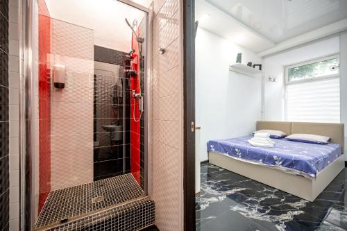 a small bathroom with a shower and a bed at Hotel No 9 in Odesa