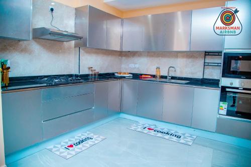 a kitchen with two controllers on the floor at Marksman bnb in Mombasa