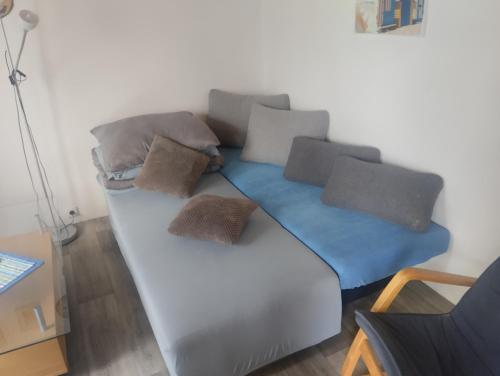 a couch with pillows on it in a room at Domek u rodinného domu in Hradec Králové