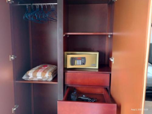 a cupboard with a microwave and a box in it at OCEAN BREEZE - WAVES LUXURY CONDO in Negombo