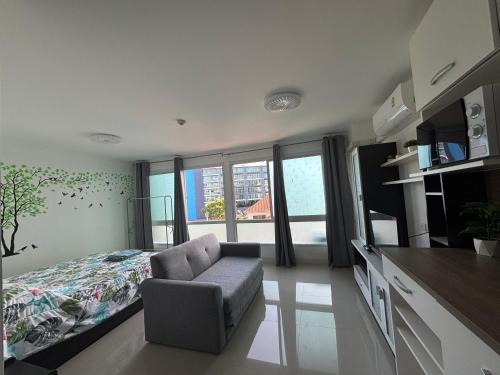 a bedroom with a bed and a chair in a room at Bangsaray Beach Condo B414 บางเสร่ บีช in Bang Sare