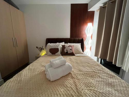 a bedroom with a large bed with a white pillow on it at Le Signature in Manila
