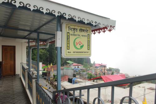 a sign on the side of a building at Nijung Homestay, Dowhill in Kurseong