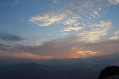 a view of a cloudy sky at sunset at Nijung Homestay, Dowhill in Kurseong