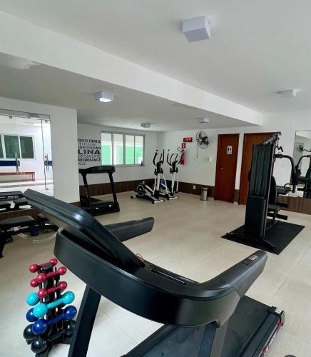 a gym with several treadmills and exercise equipment at Condomínio Beach Place Cumbuco. Ap: 206, Bloco 2 Paradise... in Caucaia