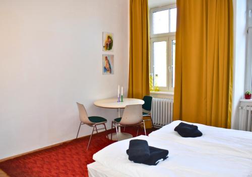 a hotel room with two beds and a table and chairs at vintage house - LGBTQ & female friendly in Vienna