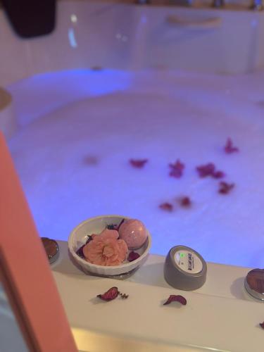 a bowl of flowers in front of a pool of water at Kandybos Eco Farm Village in Kas