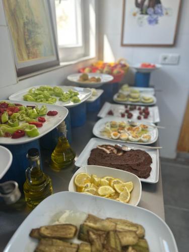 a buffet with plates of food on a table at Kandybos Eco Farm Village in Kas