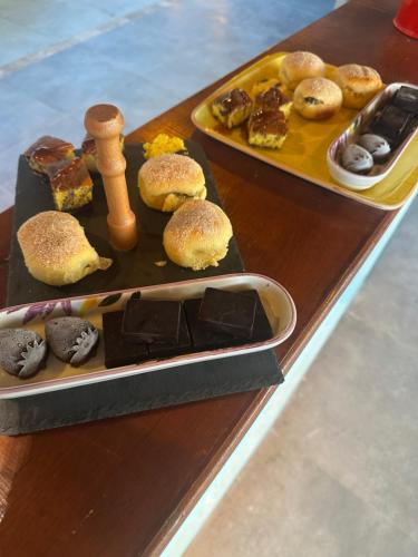 a table with two trays of different types of desserts at Kandybos Eco Farm Village in Kas