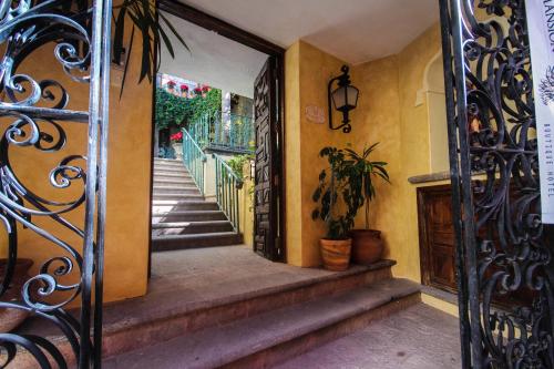 
a stairway leading to a room with a balcony at Mansion San Miguel in San Miguel de Allende
