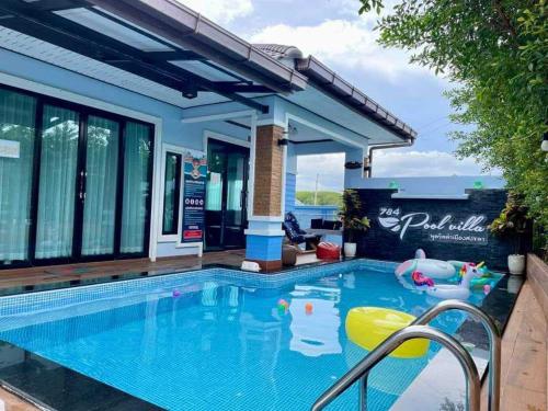 a swimming pool with a pool noodle in a house at 784 poolvilla พูลวิลล่า in Ban Khao Rup Chang