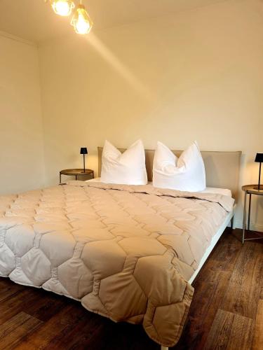 a bedroom with a large bed with white pillows at City Apartment in Olpe in Olpe