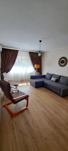 a living room with a couch and a chair at Relax Apartament in Constanţa