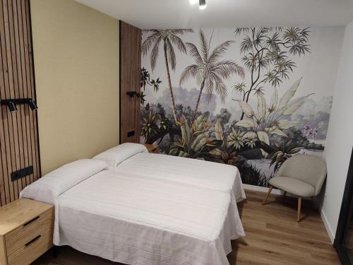 a bedroom with a bed and a mural of palm trees at Cabañita Playa da Lanzada in Sanxenxo