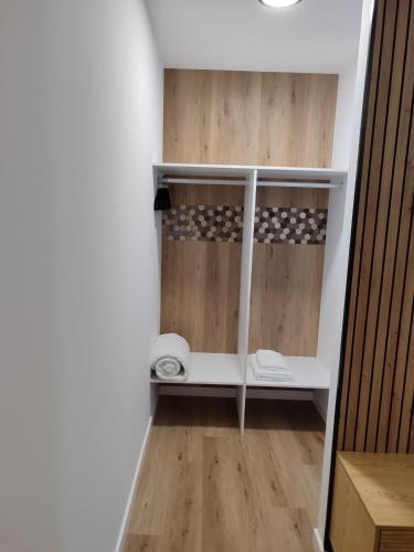 a room with a closet with wooden floors and walls at Cabañita Playa da Lanzada in Sanxenxo