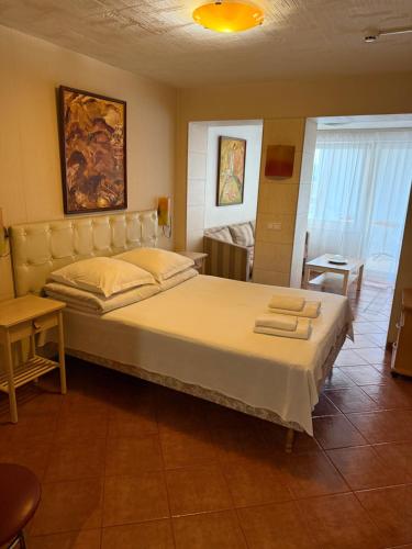 a bedroom with a large bed with towels on it at Velga in Vilnius