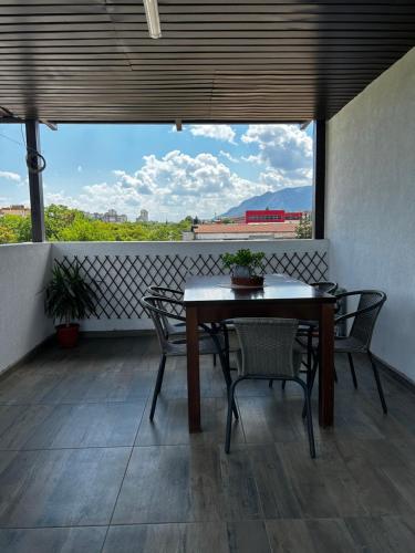 a table and chairs on a balcony with a view at Стаи за гости Крис in Vratsa