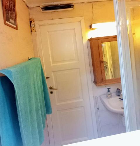 a bathroom with a white door and a sink at Room2B in Bergen