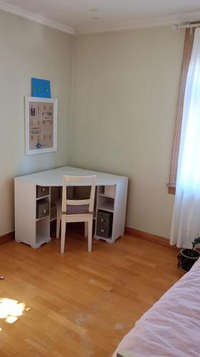 a white desk with a chair in a room at Room2B in Bergen
