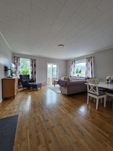 a large living room with a bed and a desk at Nordbakks holiday apartments in Frostviken, Gäddede in Gäddede