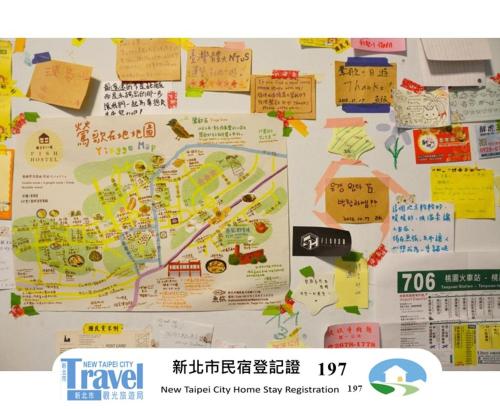 a map on a wall with signs on it at Fish Hostel in Yingge