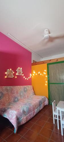 a room with a bed and a colorful wall at Casa Rural Reyes in Nuévalos