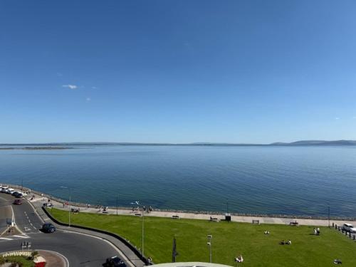a large body of water with a street and a road at Galway Beach Penthouse in Galway