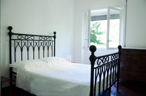 a black bed in a white bedroom with a window at Dolcevita suite in Rome