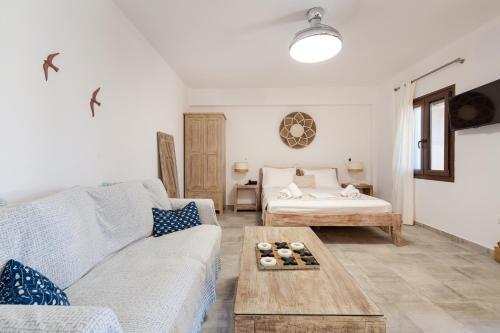 a living room with a couch and a table at Marilia ViIlage Spathi Kea "Studio The Goat" in Spathi 