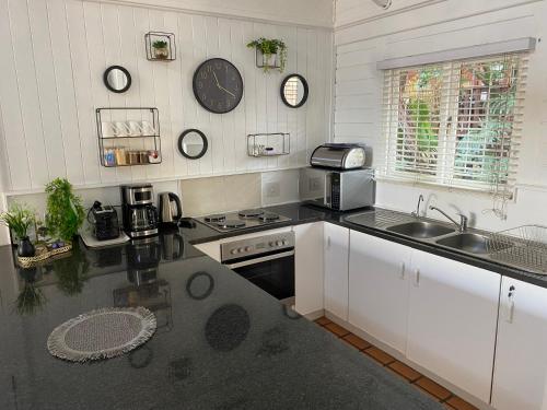 a kitchen with a sink and a stove top oven at Knysna Retreat - Knysna River Club in Knysna