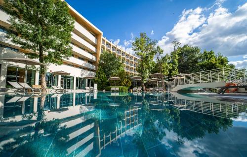 a swimming pool in front of a hotel at HVD Club Bor Ultra All Inclusive - Private Beach & Free parking in Sunny Beach