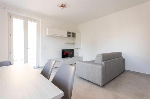 a living room with a table and a couch and a chair at Residence Risorgimento in Novara
