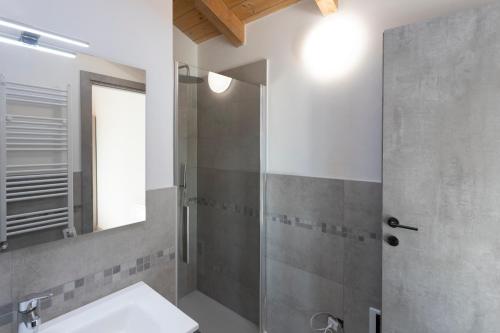 a bathroom with a shower with a sink and a mirror at Residence Risorgimento in Novara
