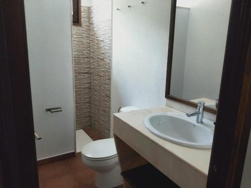 a bathroom with a sink and a toilet and a mirror at Hostal Restaurant Sant Marçal in Amer