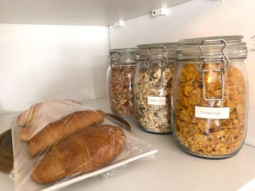 a group of jars filled with different types of bread at En-suite nook near forest & sea, great value with fridge, microwave and TV in Lymington