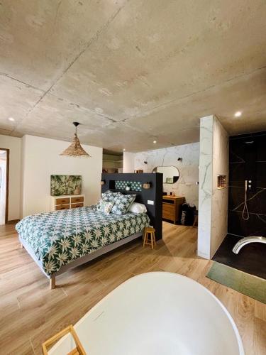 a bedroom with a large bed and a table at Villa La Forge in Parentis-en-Born