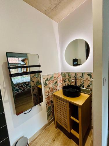 a bathroom with a sink and a mirror at Villa La Forge in Parentis-en-Born