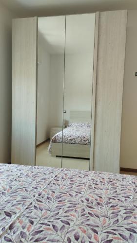 a bedroom with a bed and a large mirror at Sole e Luna in San Vito