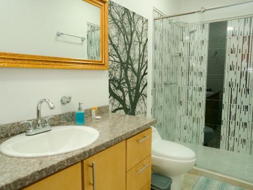 a bathroom with a sink and a toilet and a shower at Salamina Highs in Salamina