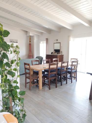 a dining room with a wooden table and chairs at COUNTRY HOUSE ViLLA GIGINA in San Gregorio