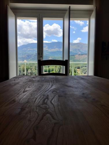 a bedroom with a bed with a view of the mountains at COUNTRY HOUSE ViLLA GIGINA in San Gregorio