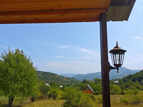 a light on a pole with a view of mountains at Qusarion - ქუსარიონი in Agara