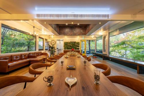 a large room with a long wooden table and chairs at 2 Onsens in-Villa #Private hot-spring Villa in Hakone in Hakone