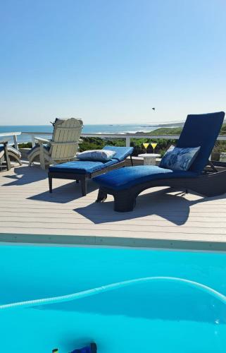 a couple of lounge chairs and a swimming pool at The Starfish View in Grotto Bay