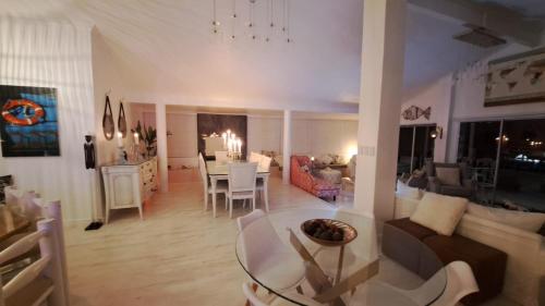 a living room with a table and a dining room at The Starfish View in Grotto Bay