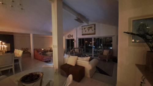a living room with a couch and a dining room at The Starfish View in Grotto Bay