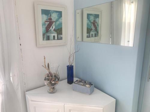a white room with a shelf with a mirror at The Starfish View in Grotto Bay