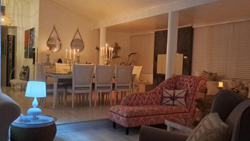 a living room with a table and a dining room at The Starfish View in Grotto Bay